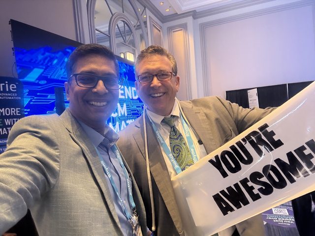 Selfie with a You're Awesome sign on the exhibit floor, Becker's HIT + RCM 2026, photo 3 of 8
